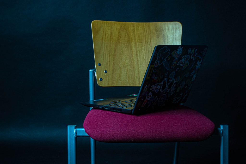 Fotografía artística, se muestra una silla con un portátil en ella. Es una crítica social, que hace referencia a como cada vez más, los artistas digitales ceden ante la existencia y uso de la IA en proyectos artísticos y el como esto se considera "arte".
